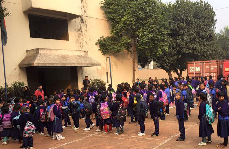 children standing outside a school in Bangladesh