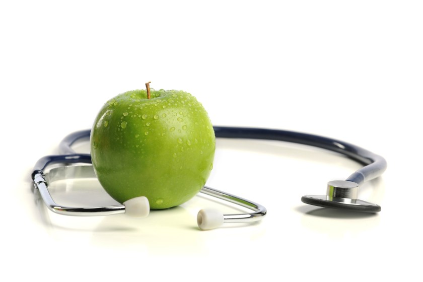 Stethoscope and Apple isolated on a white background