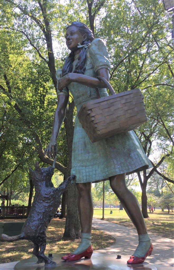 a statue of Dorothy and Toto from the Wizard of Oz