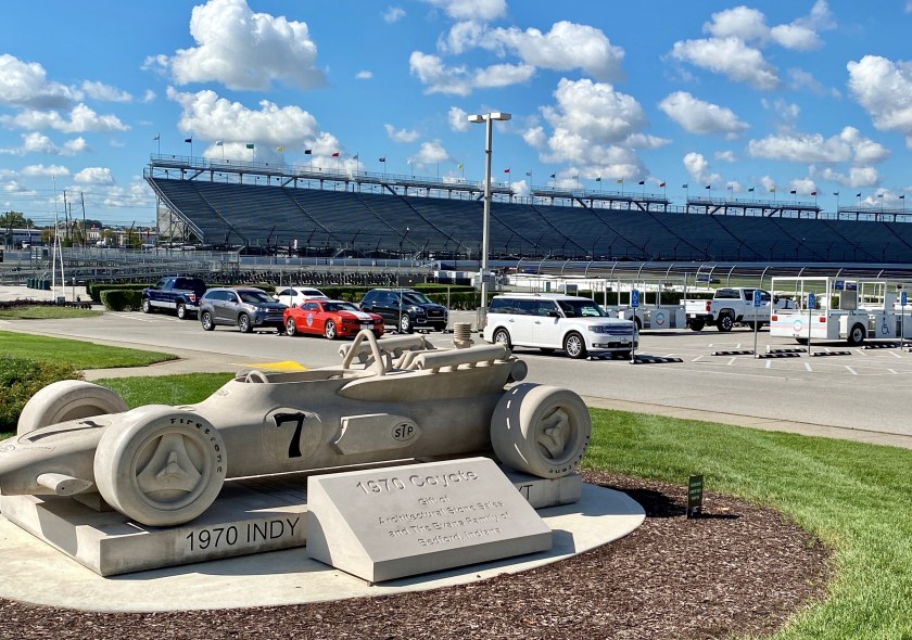 a marble statue of an INDY racecar and view of the stands