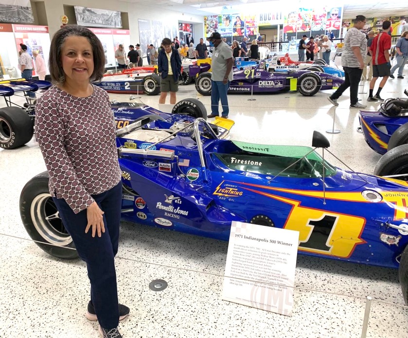 DR ALETHA STANDING BY AN INDY CAR
